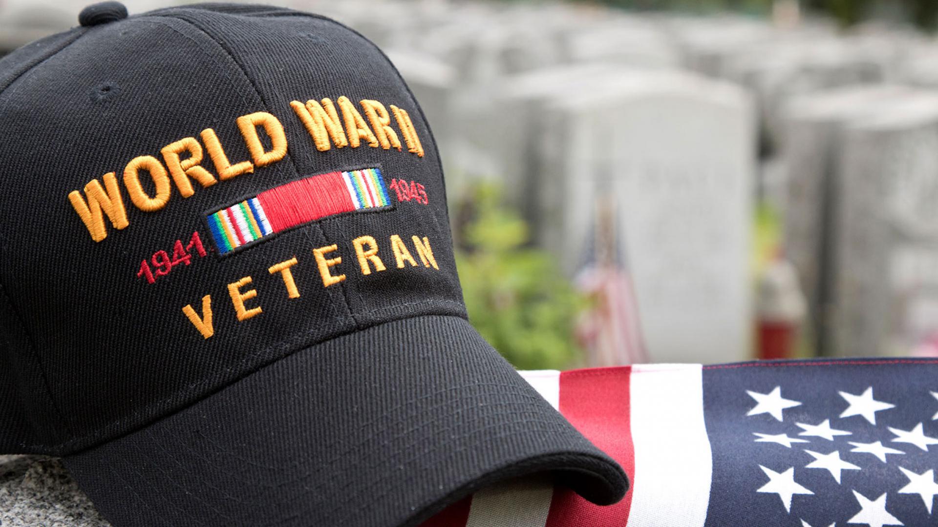 Picture of WWII Veteran hat resting on American Flag