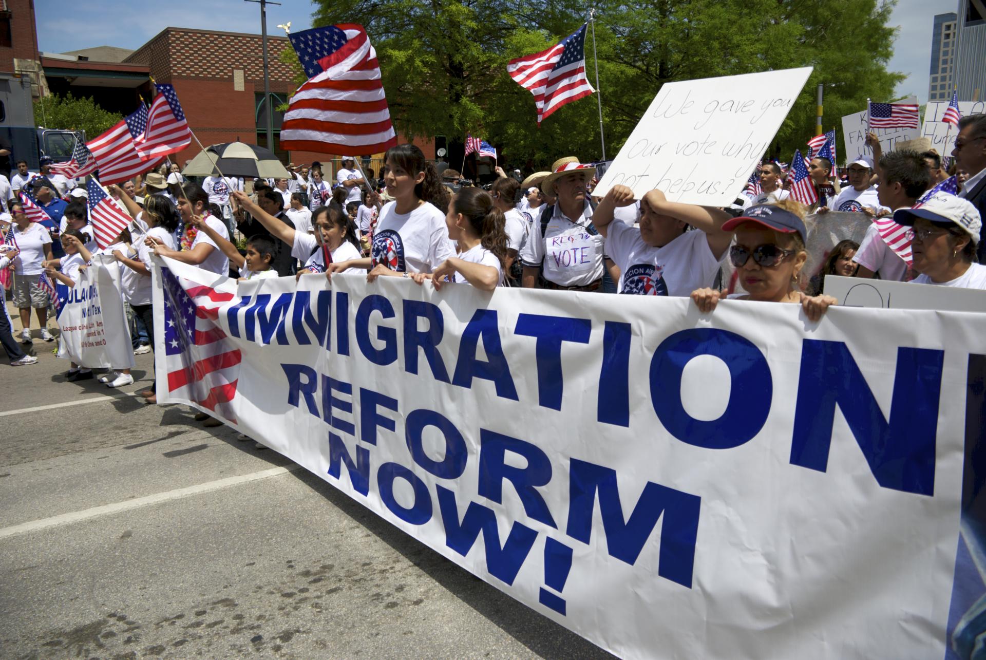 Photo of people holding Immigration Refom Now banner at a rally or protest
